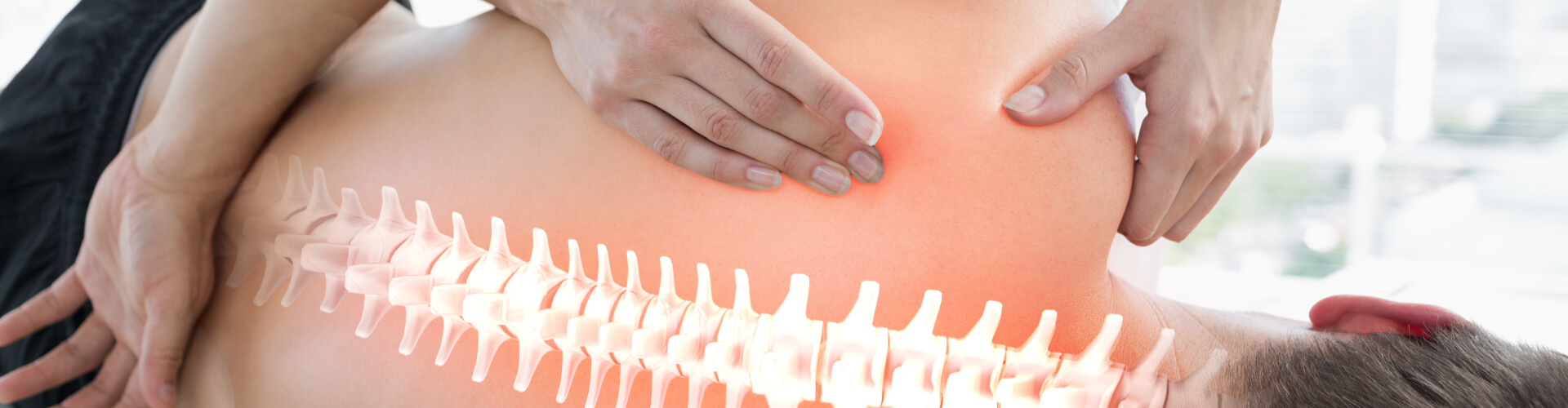 A woman holds a therapy tool in hand during an exam at Bird Chiropractic.